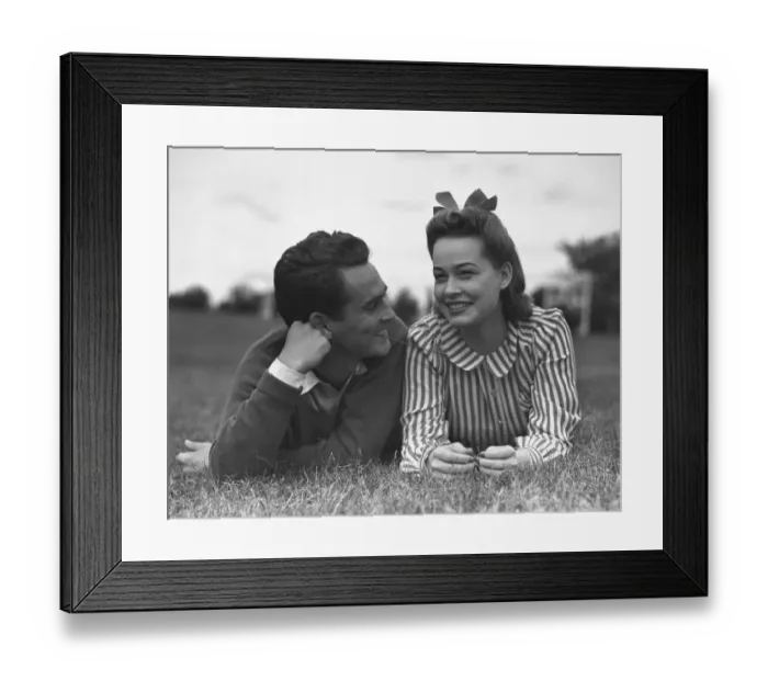 Framed Print : Young couple lying on grass Framed Print : Young couple lying on grass