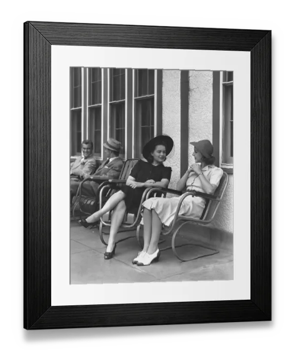 Framed Print : Two elegant women sitting on armchairs outdoors, (B&W)