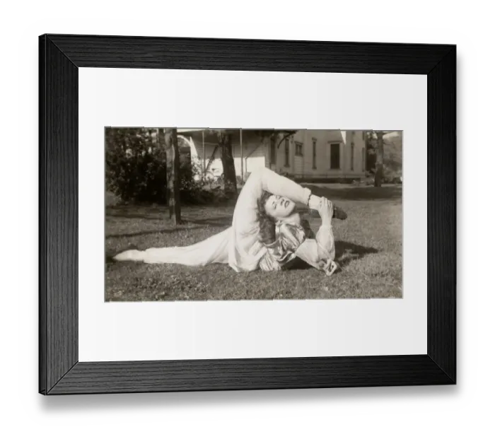 Framed Print : Flexible Woman in a Garden Bending Her Leg Above Her Head Framed Print : Flexible Woman in a Garden Bending Her Leg Above Her Head