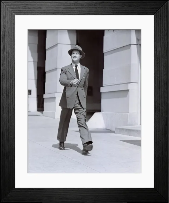 Framed Print : Man walking along sidewalk Framed Print : Man walking along sidewalk