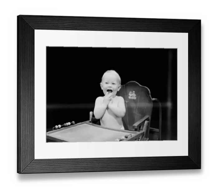 Framed Print : Baby boy (6-11 months) sitting in high chair and laughing Framed Print : Baby boy (6-11 months) sitting in high chair and laughing