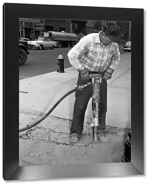 Man using jackhammer on sidewalk, (B&W)