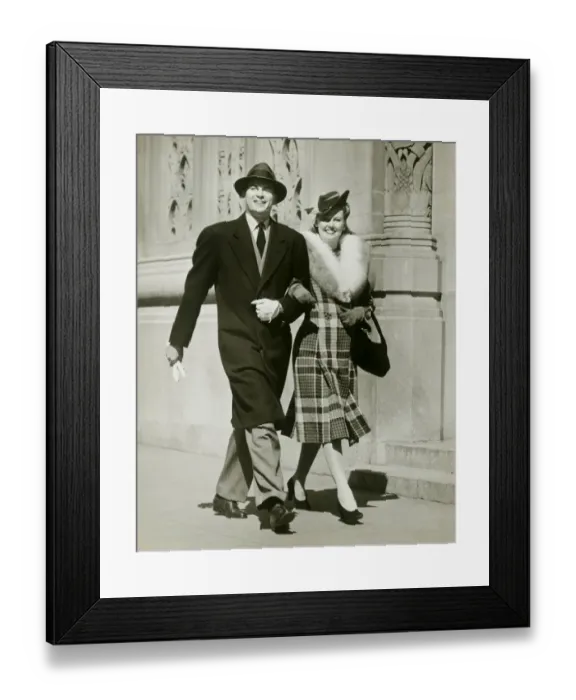 Framed Print : Couple walking arm in arm in street Framed Print : Couple walking arm in arm in street