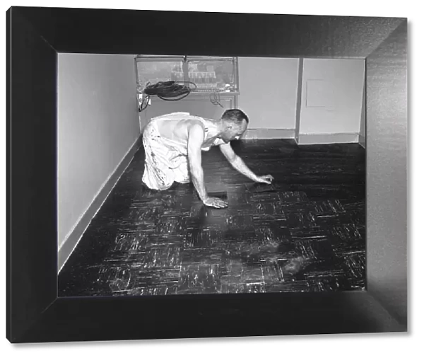 Man laying tiles on floor, (B&W)