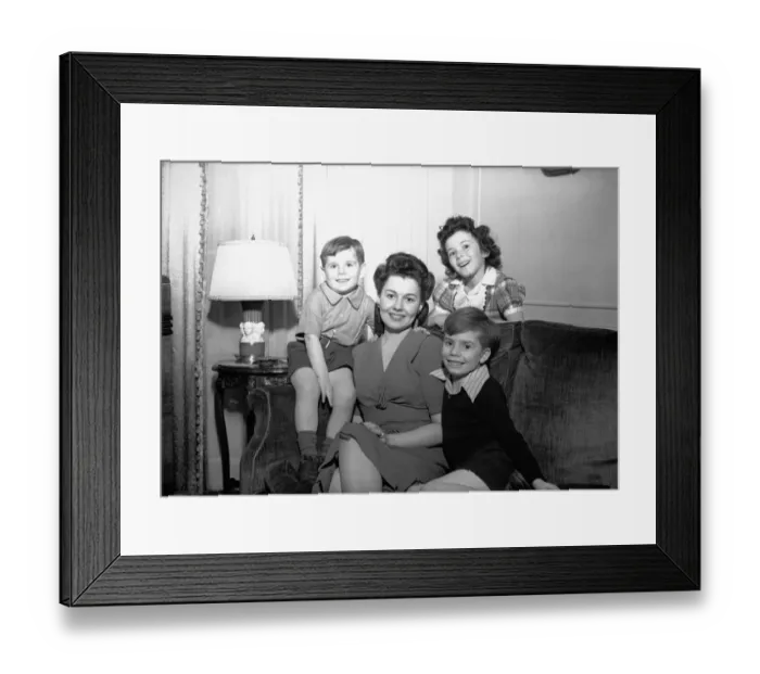 Framed Print : Mother with three children (4-5, 6-7, 8-9) posing in living room, (B&W), portrait Framed Print : Mother with three children (4-5, 6-7, 8-9) posing in living room, (B&W), portrait