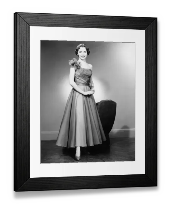 Framed Print : Woman in evening dress posing in studio (B&W), portrait Framed Print : Woman in evening dress posing in studio (B&W), portrait