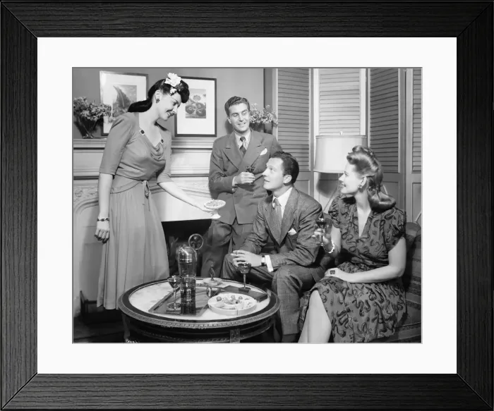 Framed Print : Couple entertaining friends (B&W) Framed Print : Couple entertaining friends (B&W)