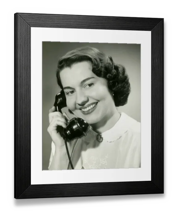 Framed Print : Woman talking on phone, close-up, studio shot Framed Print : Woman talking on phone, close-up, studio shot