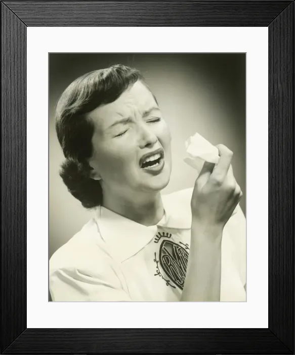 Framed Print : Woman sneezing, studio shot Framed Print : Woman sneezing, studio shot