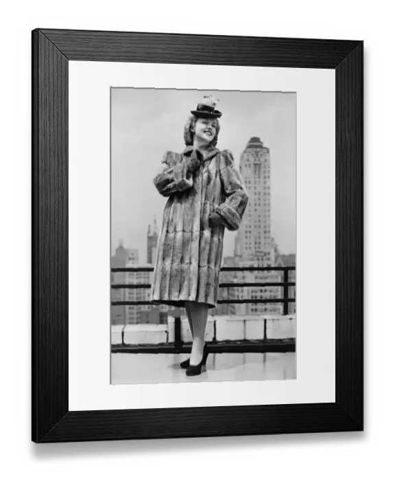 Framed Print : Woman in fur coat and fancy hat standing on outside terrace (B&W) Framed Print : Woman in fur coat and fancy hat standing on outside terrace (B&W)