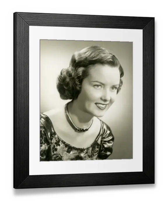 Framed Print : Young woman smiling, close-up, studio shot Framed Print : Young woman smiling, close-up, studio shot