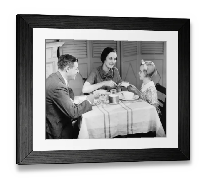 Framed Print : Parents with daughter (8-9) eating breakfast at home (B&W) Framed Print : Parents with daughter (8-9) eating breakfast at home (B&W)