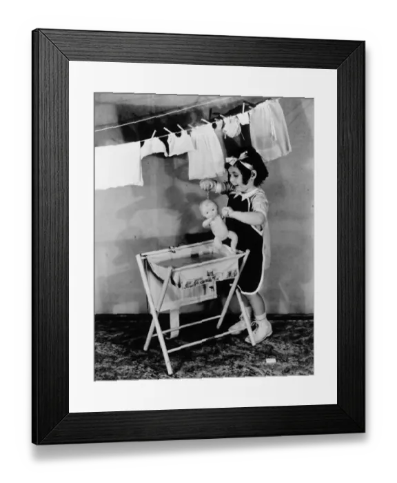 Framed Print : Girl (4-5) playing with doll (B&W) Framed Print : Girl (4-5) playing with doll (B&W)