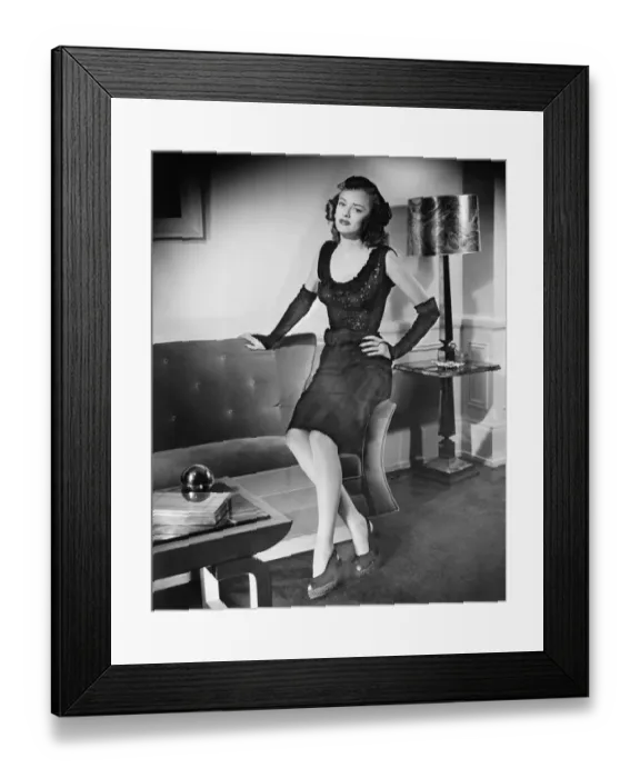 Framed Print : Elegant woman sitting on sofa (B&W), portrait Framed Print : Elegant woman sitting on sofa (B&W), portrait