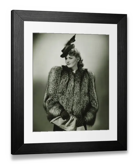 Framed Print : Young woman in fur coat and fashionable hat in studio, (B&W) Framed Print : Young woman in fur coat and fashionable hat in studio, (B&W)