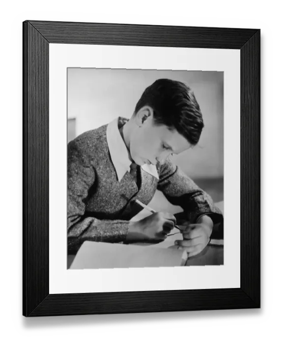 Framed Print : Boy (10-11) writing in notebook (B&W) Framed Print : Boy (10-11) writing in notebook (B&W)