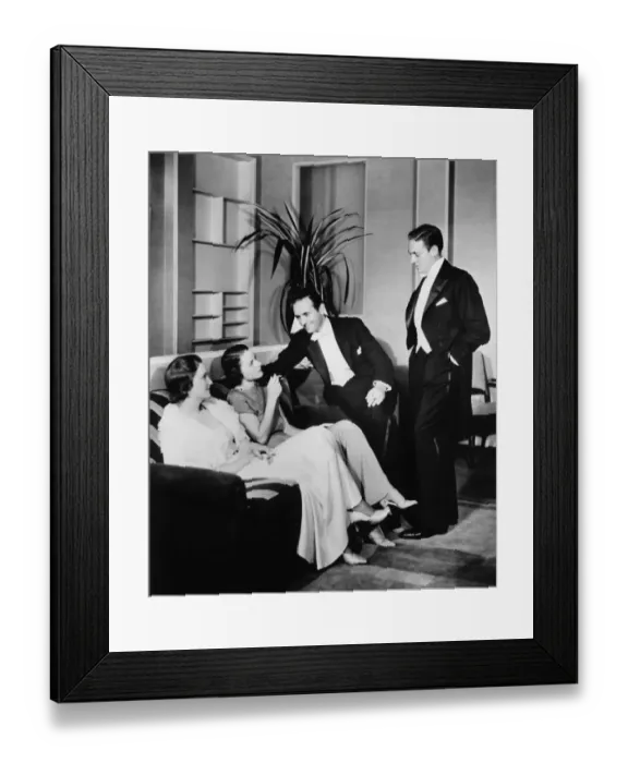 Framed Print : People in evening wear talking in living room (B&W) Framed Print : People in evening wear talking in living room (B&W)