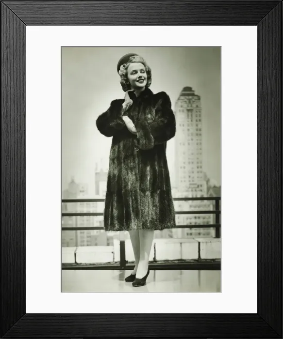 Framed Print : Young woman in fur coat standing outdoors, (B&W) Framed Print : Young woman in fur coat standing outdoors, (B&W)