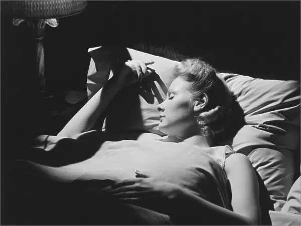 Young woman sleeping in bed (B&W)