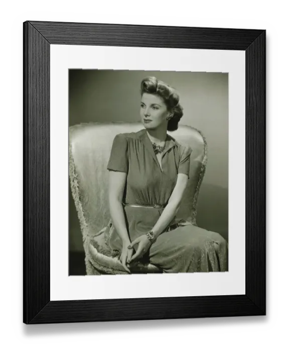Framed Print : Young woman sitting on chair indoors, (B&W)