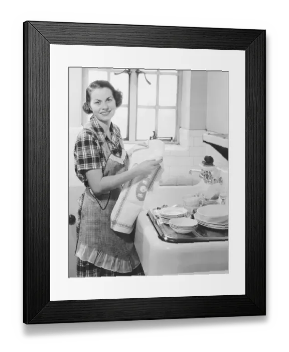 Framed Print : Young woman drying dishes in kitchen (B&W), portrait