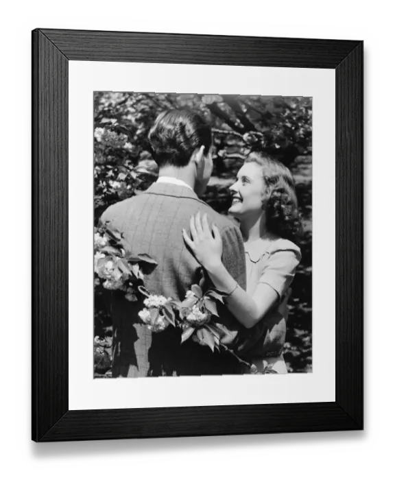 Framed Print : Couple embracing at blooming bush (B&W) Framed Print : Couple embracing at blooming bush (B&W)