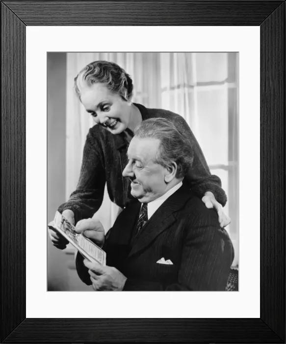 Framed Print : Mature couple looking at folder (B&W) Framed Print : Mature couple looking at folder (B&W)
