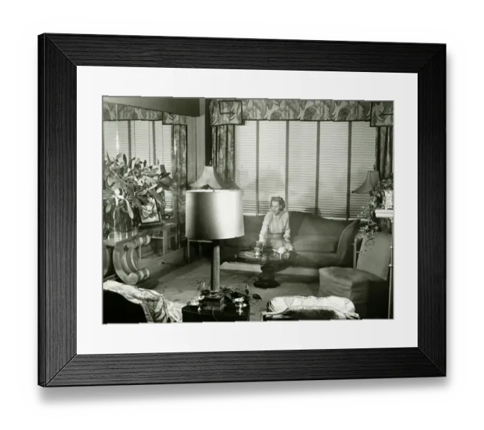 Framed Print : Woman sitting on couch in opulent living room, (B&W) Framed Print : Woman sitting on couch in opulent living room, (B&W)