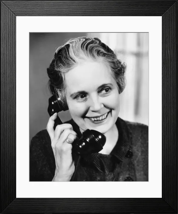 Framed Print : Mature woman talking on phone (B&W) Framed Print : Mature woman talking on phone (B&W)