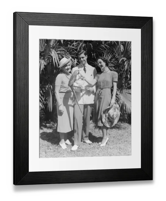 Framed Print : Young couple and mature woman looking at parrot (B&W) Framed Print : Young couple and mature woman looking at parrot (B&W)