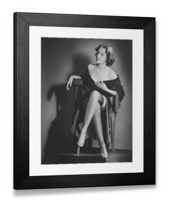 Framed Print : Fashionable woman posing in studio, showing legs, (B&W), portrait Framed Print : Fashionable woman posing in studio, showing legs, (B&W), portrait