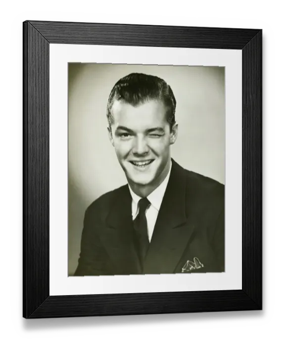 Framed Print : Young businessman winking, posing in studio, (B&W), portrait Framed Print : Young businessman winking, posing in studio, (B&W), portrait