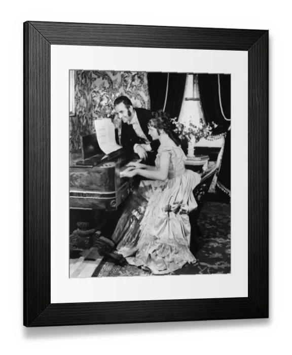 Framed Print : Man assisting woman playing on spinet (B&W) Framed Print : Man assisting woman playing on spinet (B&W)