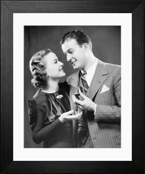 Framed Print : Man giving to fiance engagement ring in studio, (B&W), portrait Framed Print : Man giving to fiance engagement ring in studio, (B&W), portrait