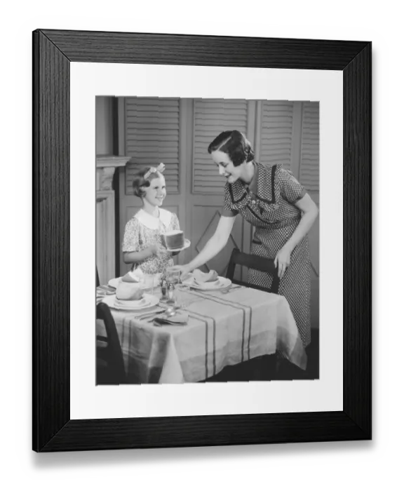 Framed Print : Mother and daughter (8-9) setting table for breakfast, (B&W) Framed Print : Mother and daughter (8-9) setting table for breakfast, (B&W)