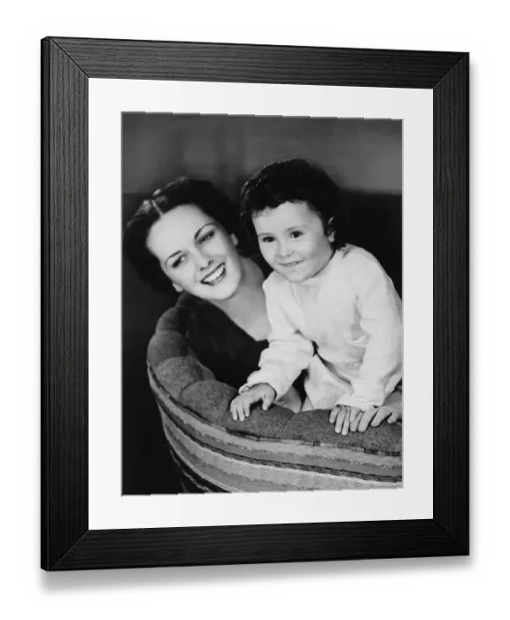 Framed Print : Mother on couch with daughter (4-5), (B&W) Framed Print : Mother on couch with daughter (4-5), (B&W)