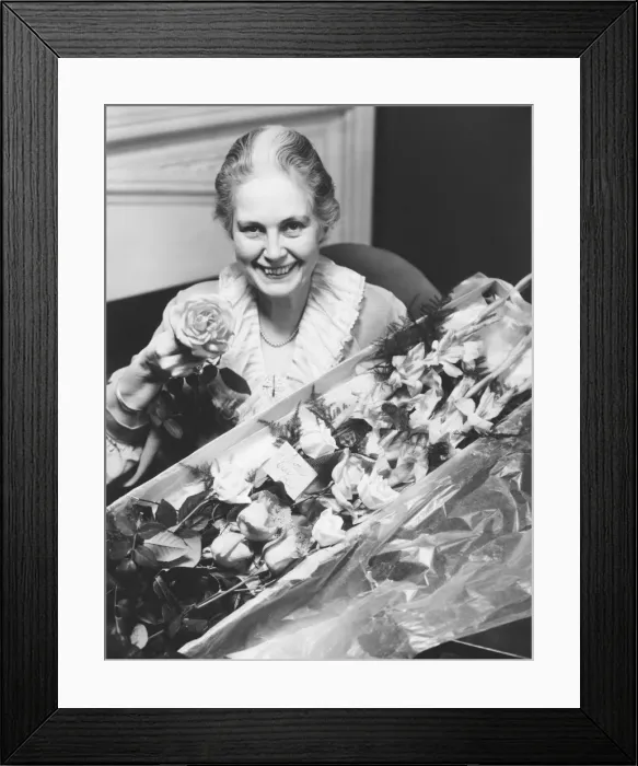 Framed Print : Senior woman holding boxed flowers, (B&W), portrait Framed Print : Senior woman holding boxed flowers, (B&W), portrait