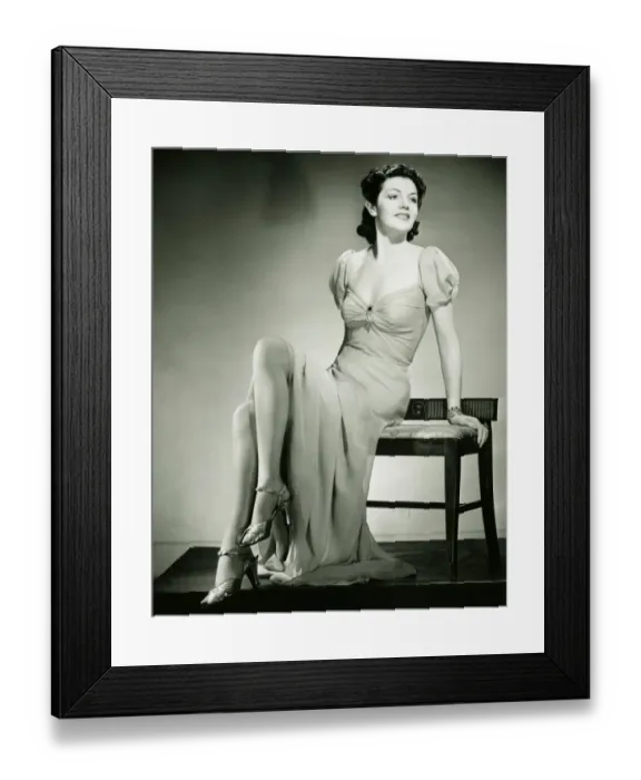 Framed Print : Young woman sitting on chair, posing, (B&W) Framed Print : Young woman sitting on chair, posing, (B&W)