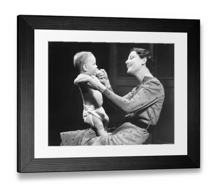 Framed Print : Woman playing with baby (6-9 months) (B&W) Framed Print : Woman playing with baby (6-9 months) (B&W)