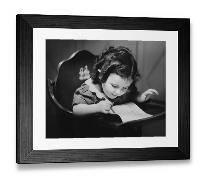 Framed Print : Young girl (2-3) in baby seat drawing, (B&W), close-up Framed Print : Young girl (2-3) in baby seat drawing, (B&W), close-up