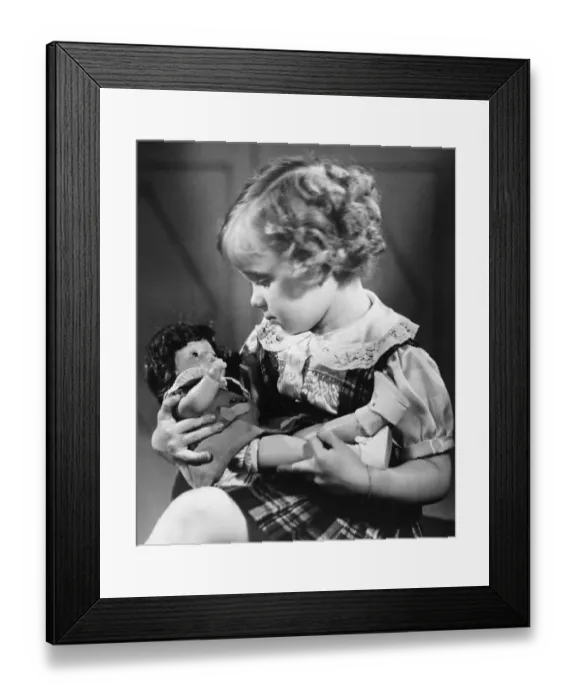 Framed Print : Girl (4-5) playing with doll (B&W) Framed Print : Girl (4-5) playing with doll (B&W)