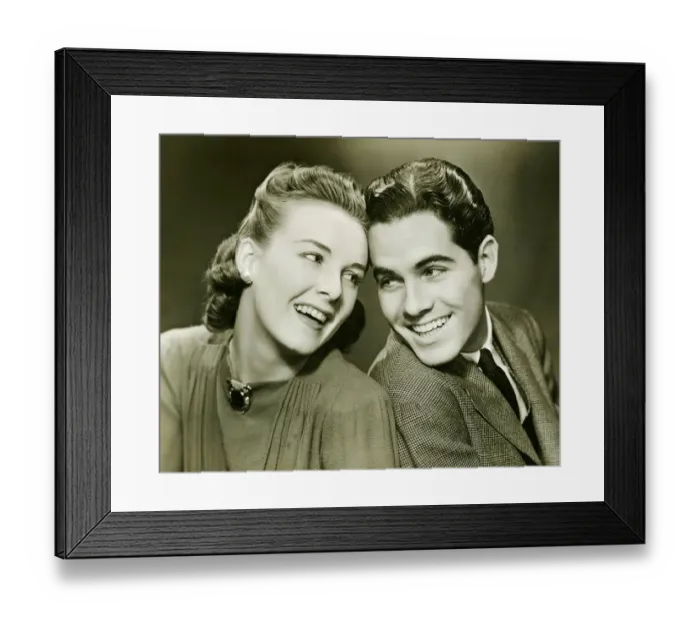 Framed Print : Young couple with head to head, smiling, (B&W) Framed Print : Young couple with head to head, smiling, (B&W)