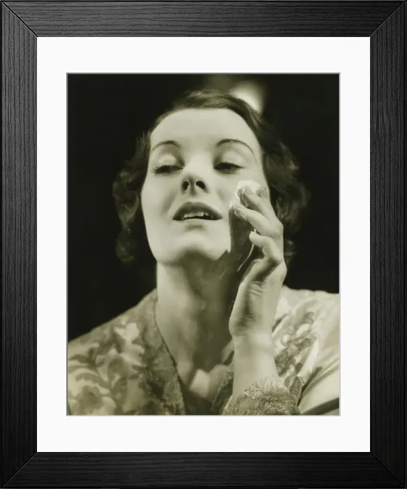 Framed Print : Woman removing make up in studio, (B&W), close-up Framed Print : Woman removing make up in studio, (B&W), close-up