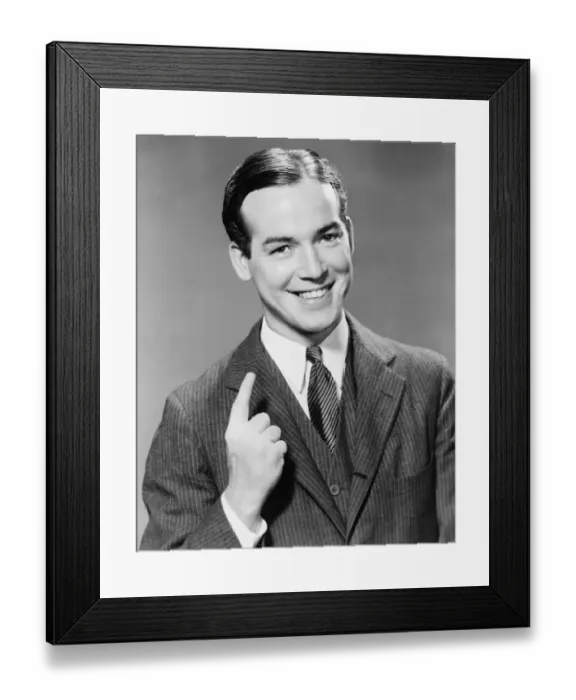 Framed Print : Young man gesturing in studio (B&W), portrait Framed Print : Young man gesturing in studio (B&W), portrait