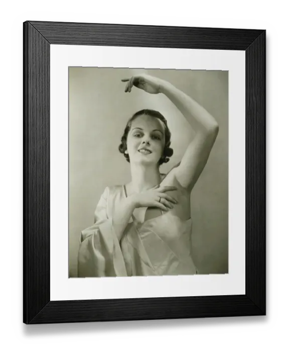 Framed Print : Young woman raising hand, posing in studio, (B&W), portrait Framed Print : Young woman raising hand, posing in studio, (B&W), portrait