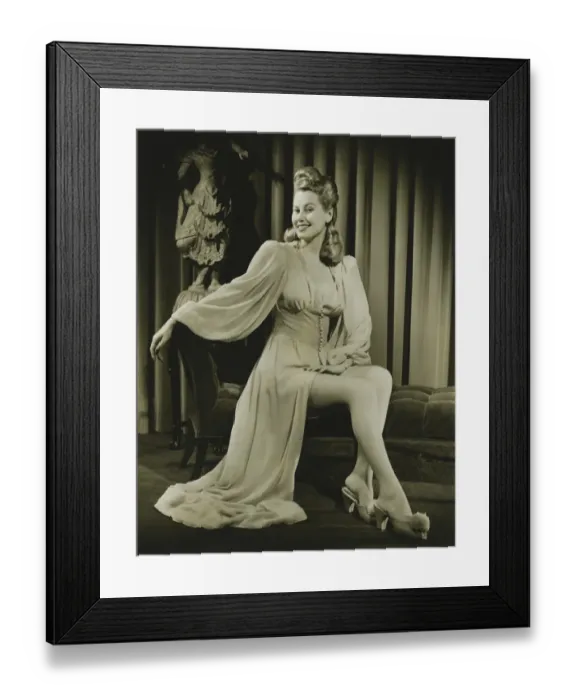 Framed Print : Young woman in fashionable nightdress sitting indoors, (B&W) Framed Print : Young woman in fashionable nightdress sitting indoors, (B&W)