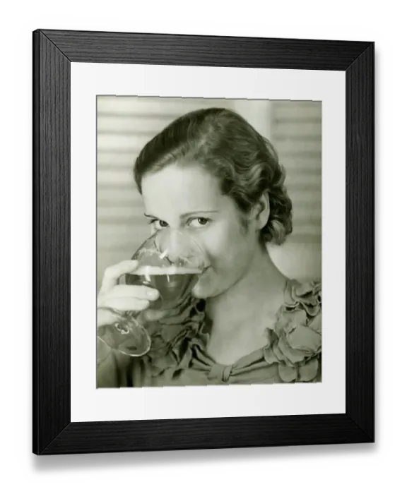 Framed Print : Young woman drinking glass of beer, (B&W), portrait