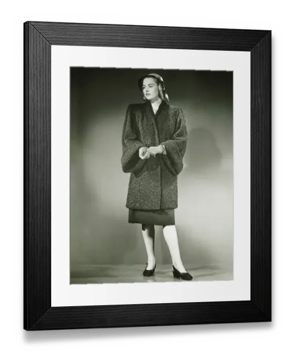 Framed Print : Young woman in Persian lamb coat standing in studio, (B&W) Framed Print : Young woman in Persian lamb coat standing in studio, (B&W)