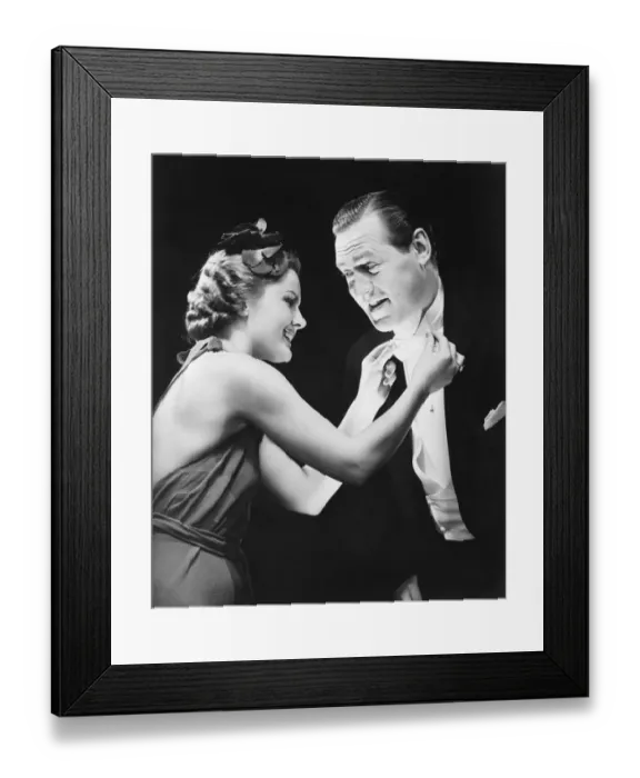 Framed Print : Woman adjusting mans bow tie (B&W) Framed Print : Woman adjusting mans bow tie (B&W)