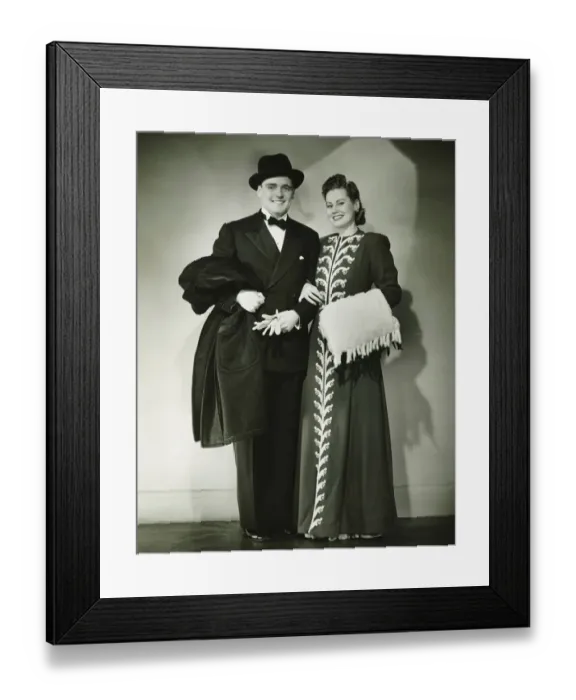 Framed Print : Young couple wearing formal dress standing in studio, (B&W) Framed Print : Young couple wearing formal dress standing in studio, (B&W)